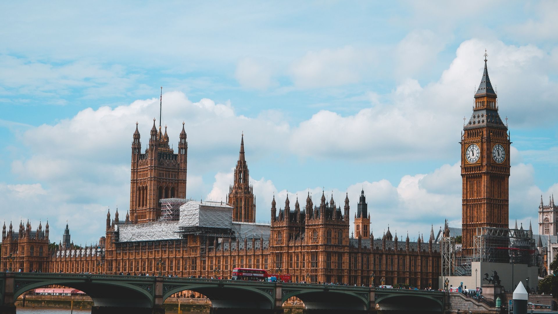 Houses of Parliament and Big Ben seen across Westminster Bridge on a cloudy day