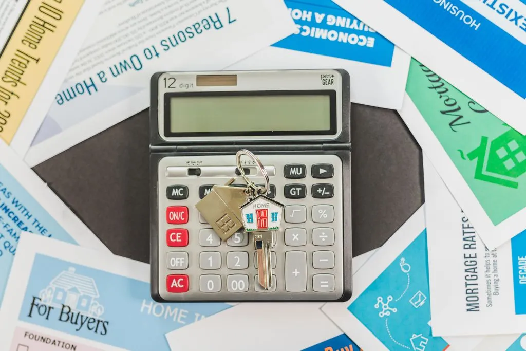 Checking the numbers before your fix ends Calculator with a house-shaped key ring on top of mortgage and home-buying leaflets